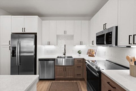 a kitchen with stainless steel appliances and white cabinets