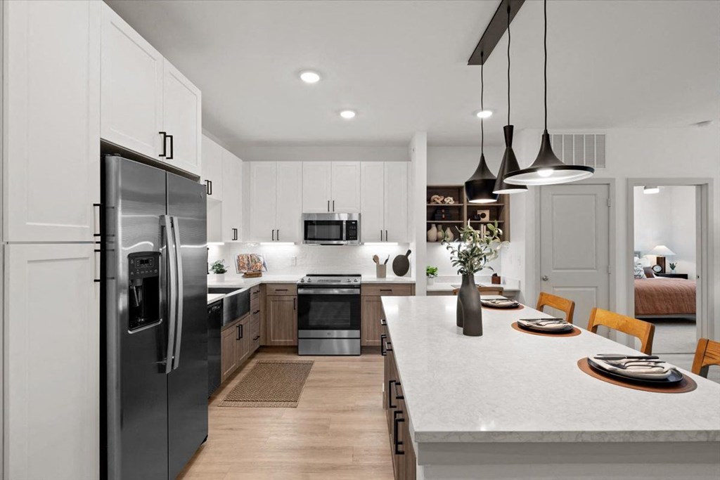 a kitchen and dining room with stainless steel appliances in Sachse, Texas