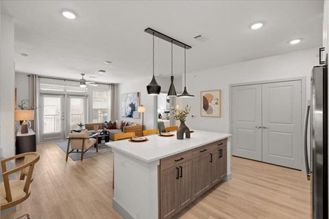 a kitchen with a center island and a living room