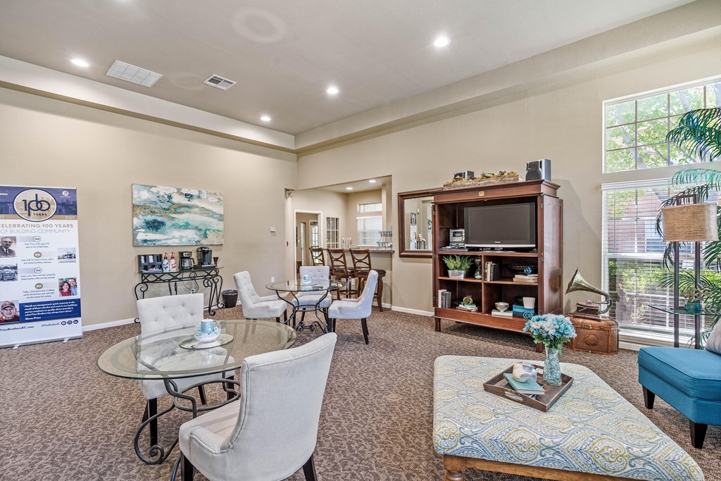 a living room filled with furniture and a large window
