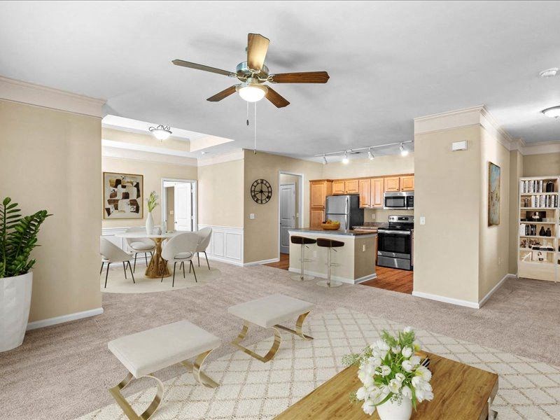 a living room and kitchen with a ceiling fan