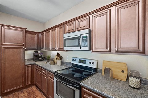 Kitchen with Cabinets at Stonepost Ranch Apartments, Overland Park, KS
