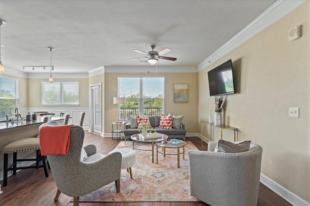 a living room with furniture and a ceiling fan