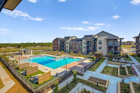 an aerial view of an apartment complex with a swimming pool