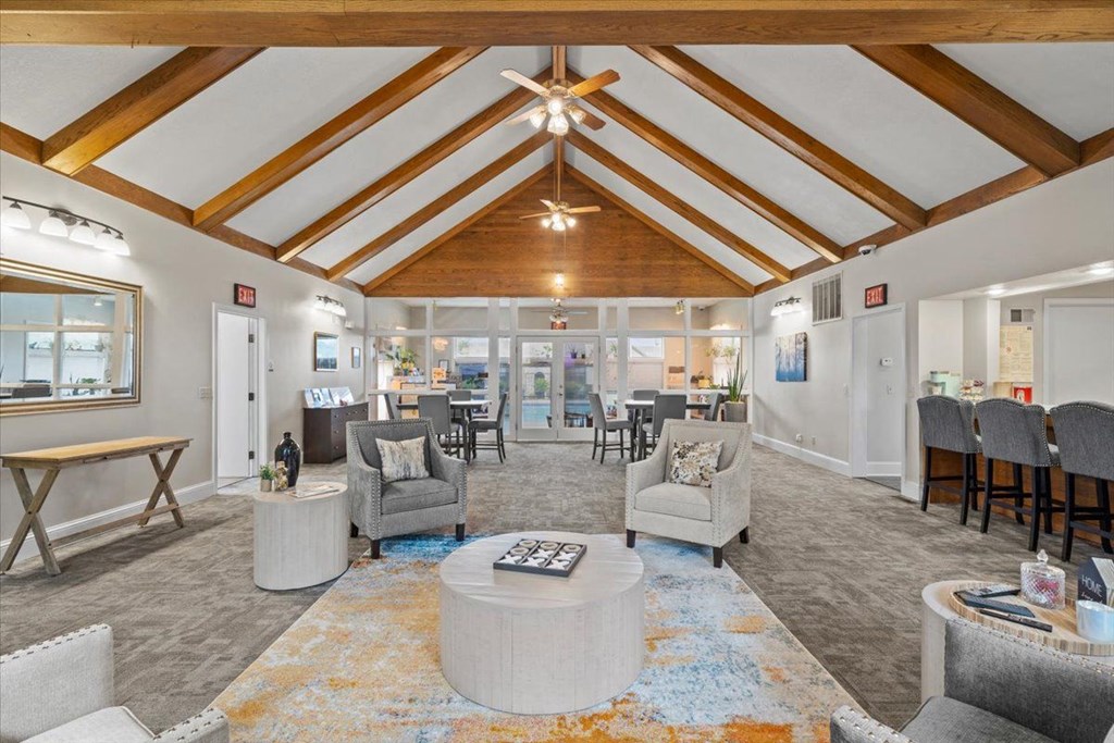 a living room with couches and chairs and a table
