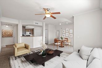 an open living room and kitchen with a ceiling fan
