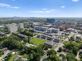 A cityscape with buildings and greenery under a clear sky. at Malvern Hill Apartment Homes, Kansas