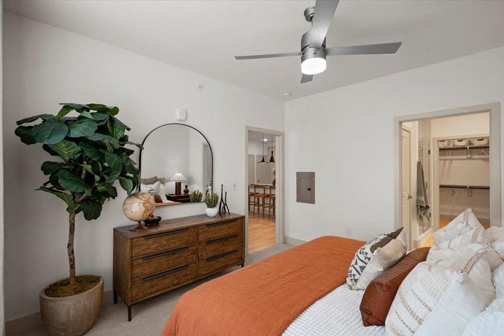 a bedroom with a bed and a mirror