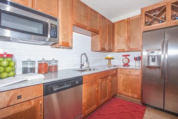 kitchen with stainless steel appliances at Ovation at Lewisville Apartments, Lewisville, TX