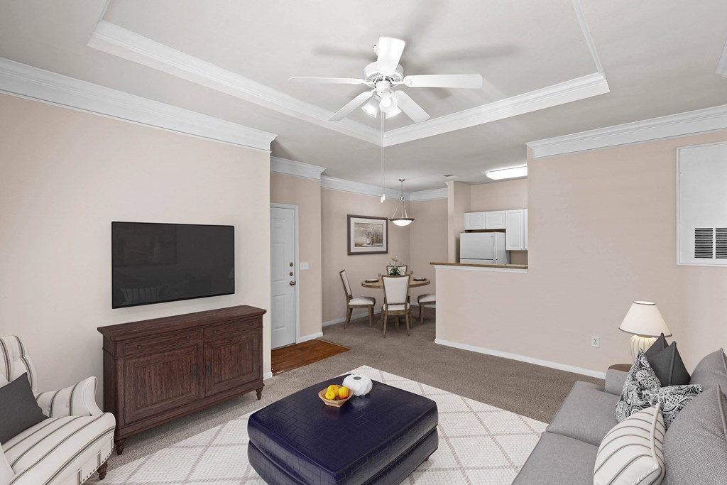 a living room filled with furniture and a flat screen tv at Creekside Apartment Homes, Kansas