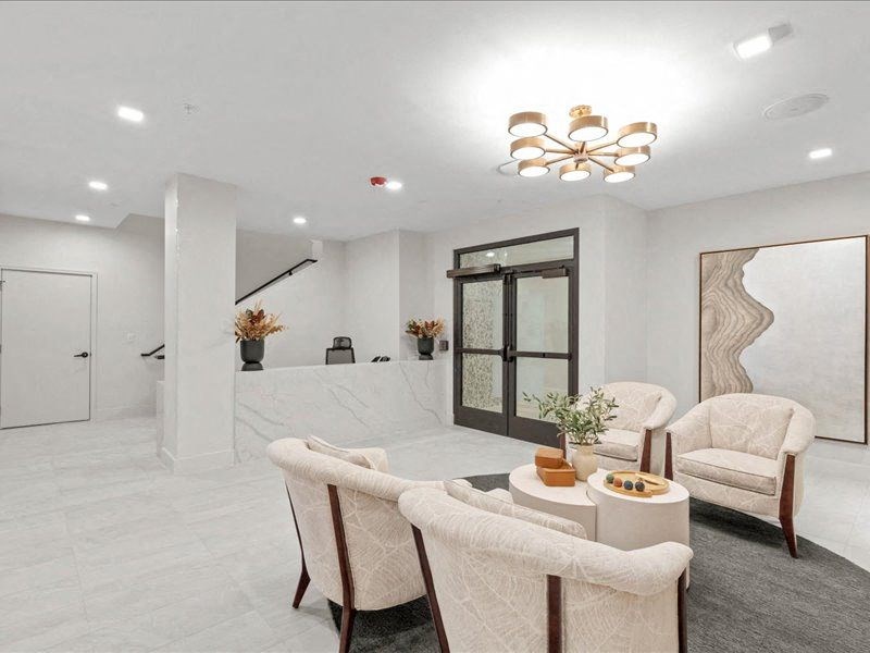 a living room with a table and chairs