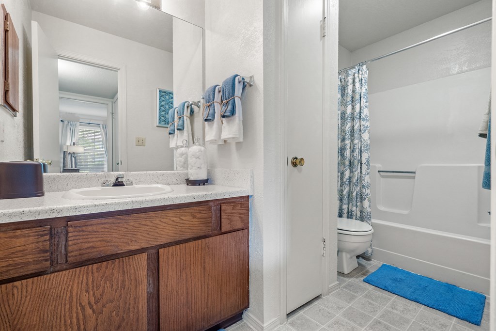 a bathroom with a sink toilet and shower at Pebblebrook, Overland Park, 66212