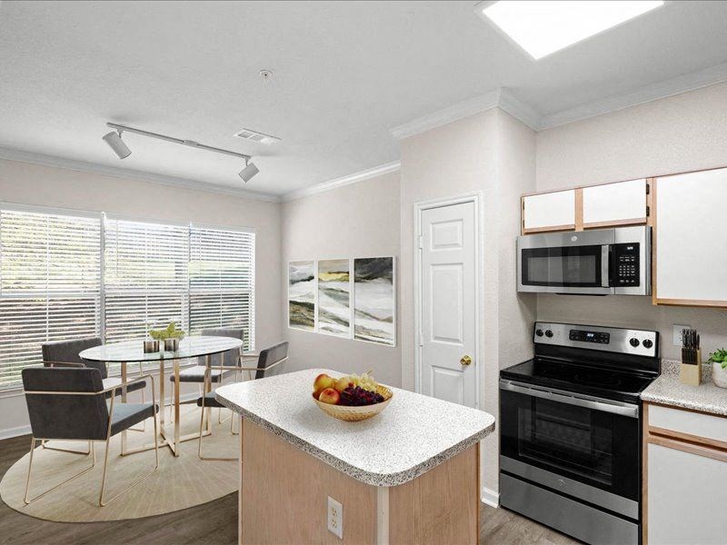 a kitchen with a bowl of fruit on the counter