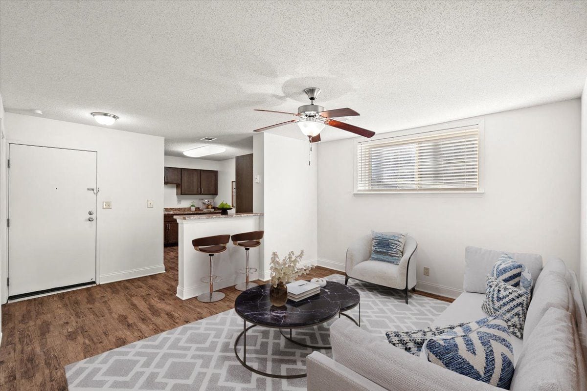 a living room with a couch and a ceiling fan
