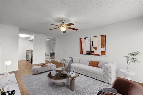 an open living room with furniture and a ceiling fan
