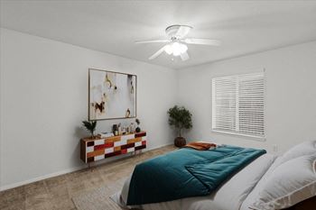 a bedroom with a bed and a ceiling fanat Millcreek Woods Apartments, Kansas, 66061