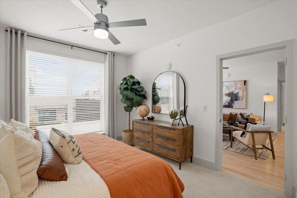 a bedroom with a bed and a ceiling fan