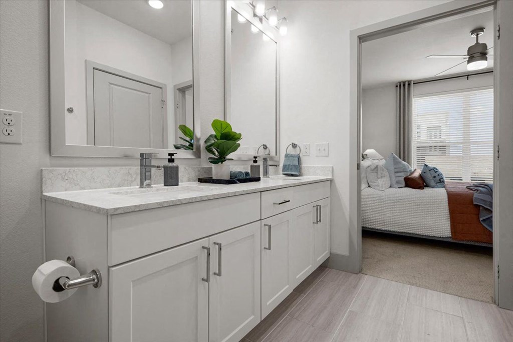 a white bathroom with a sink and a mirror