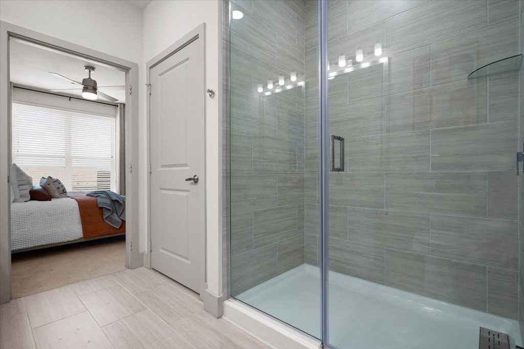 a bathroom with a shower and a bed