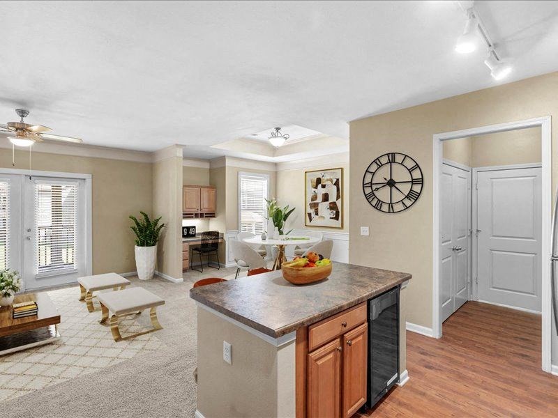 a kitchen with a counter top and a living room