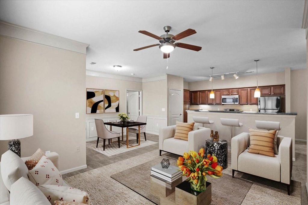 a living room with furniture and a ceiling fan