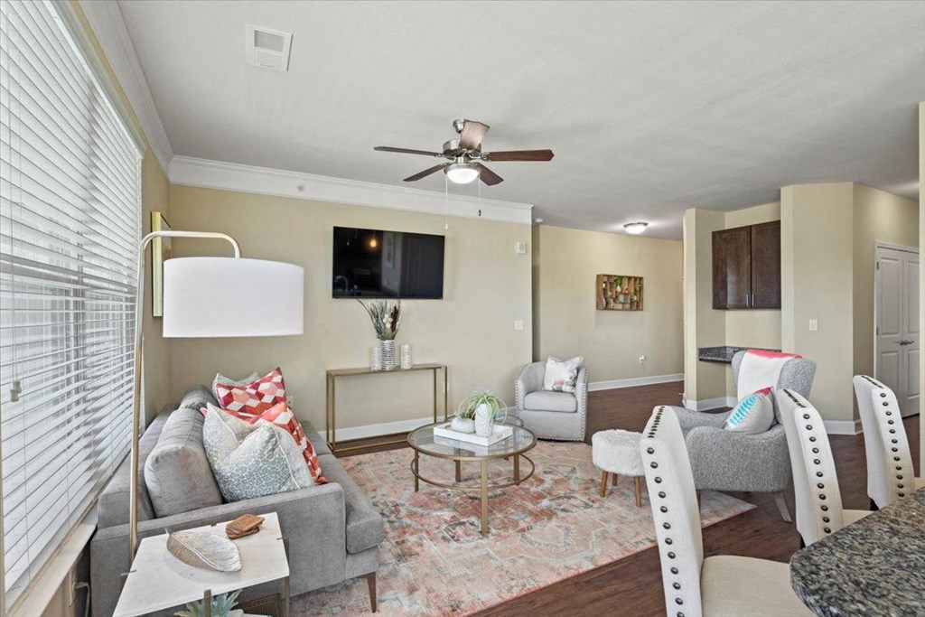 a living room with furniture and a ceiling fan