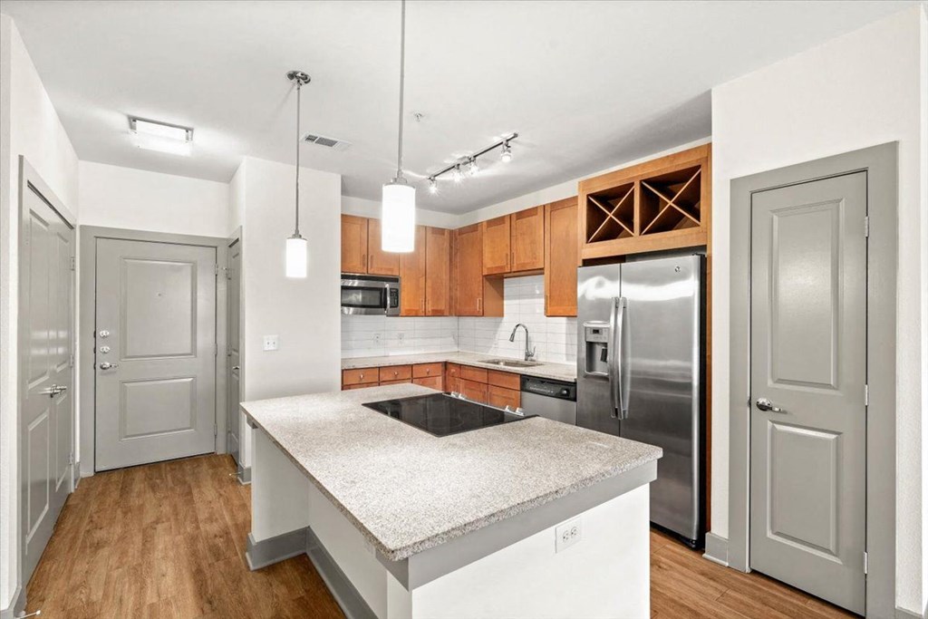 Kitchen with an island at Ovation at Lewisville Apartment Homes, Lewisville, TX, 75067