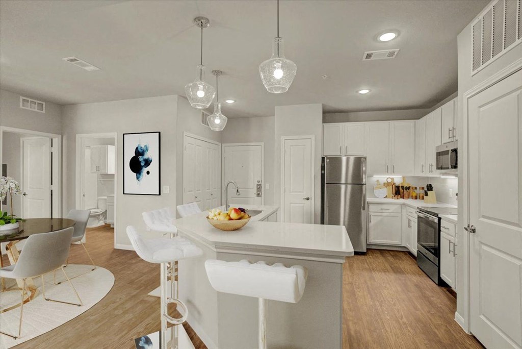 a kitchen with white cabinets and a white counter top