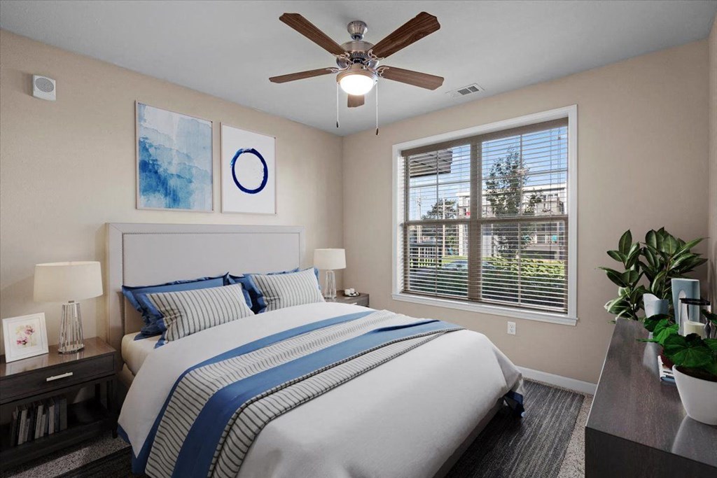 a bedroom with a large bed and a ceiling fan