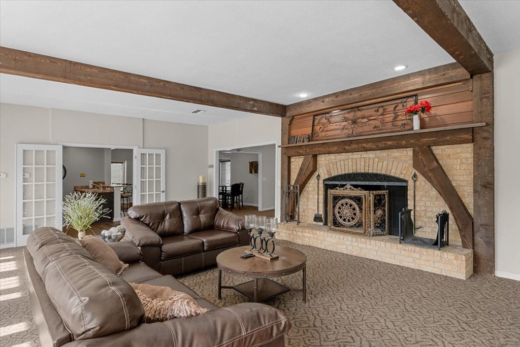 Living room with a brown leather couch  at Louisburg Square Apartments & Townhomes, Overland Park, KS, 66212