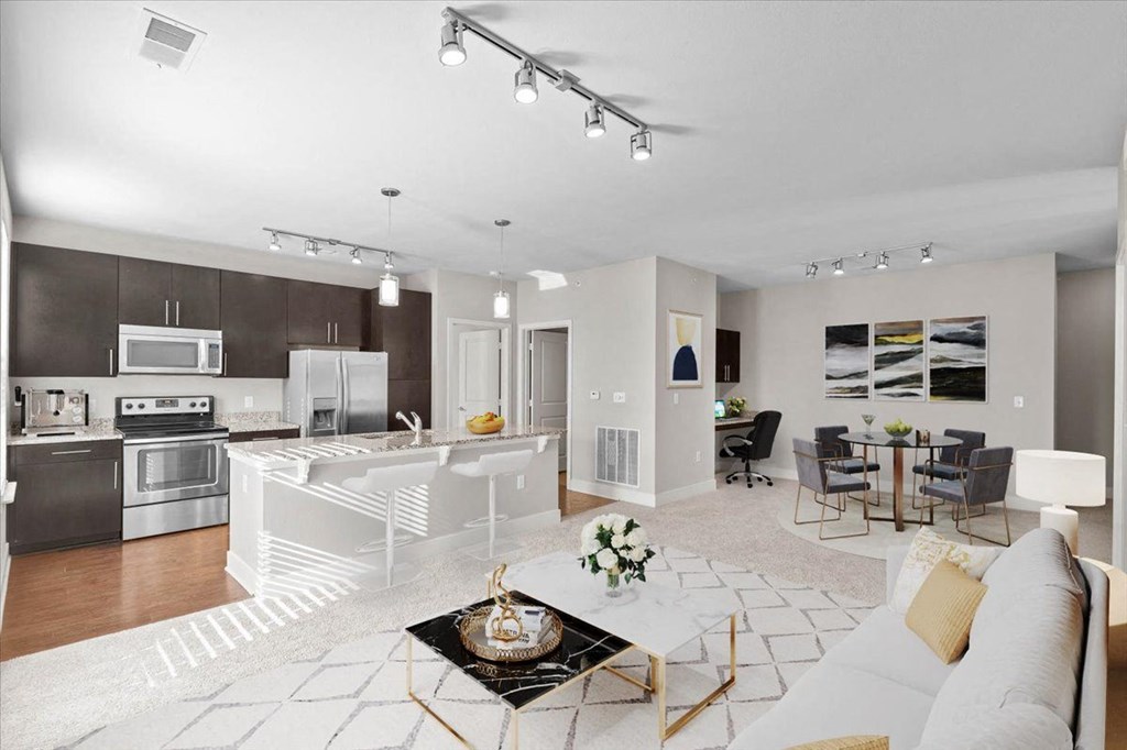 a living room and kitchen with a couch and a table