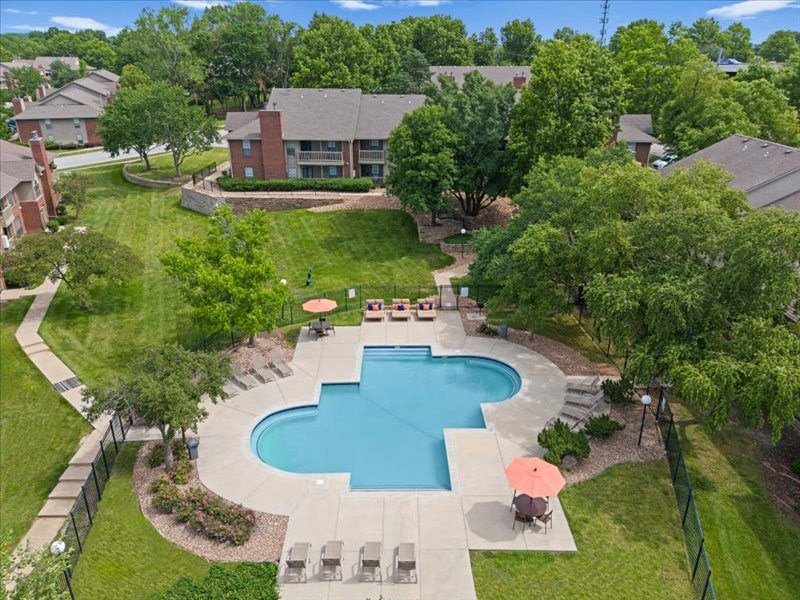 an aerial view of a swimming pool in the backyard of a house at Highland Park Apartment Homes, Overland Park