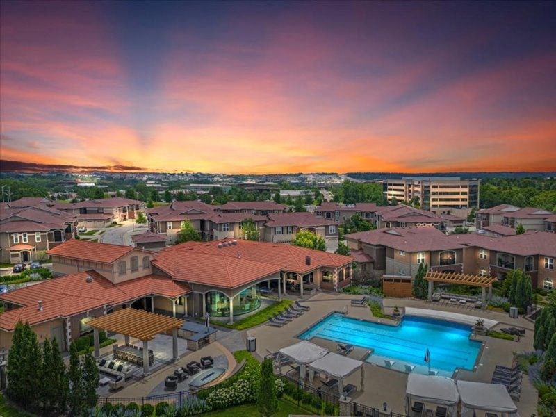 an aerial view of a resort with a swimming pool