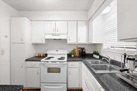 a kitchen with white appliances and white cabinets