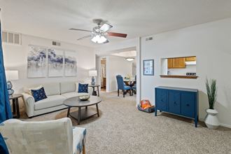 a living room with a white couch and a blue cabinet at Waterford Place Apartments & Townhomes, Kansas, 66210