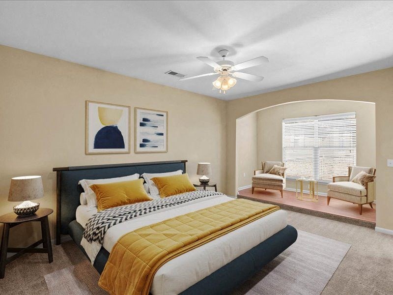 a bedroom with a bed and a ceiling fan