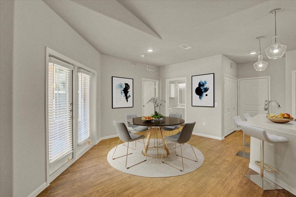 a dining room with a table and chairs