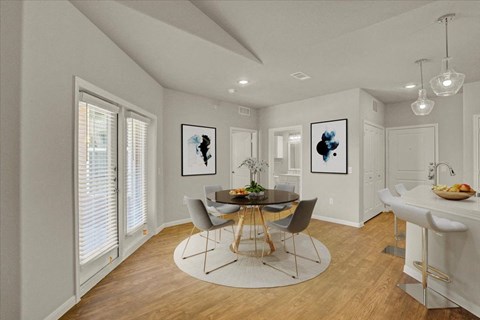 a dining room with a table and chairs