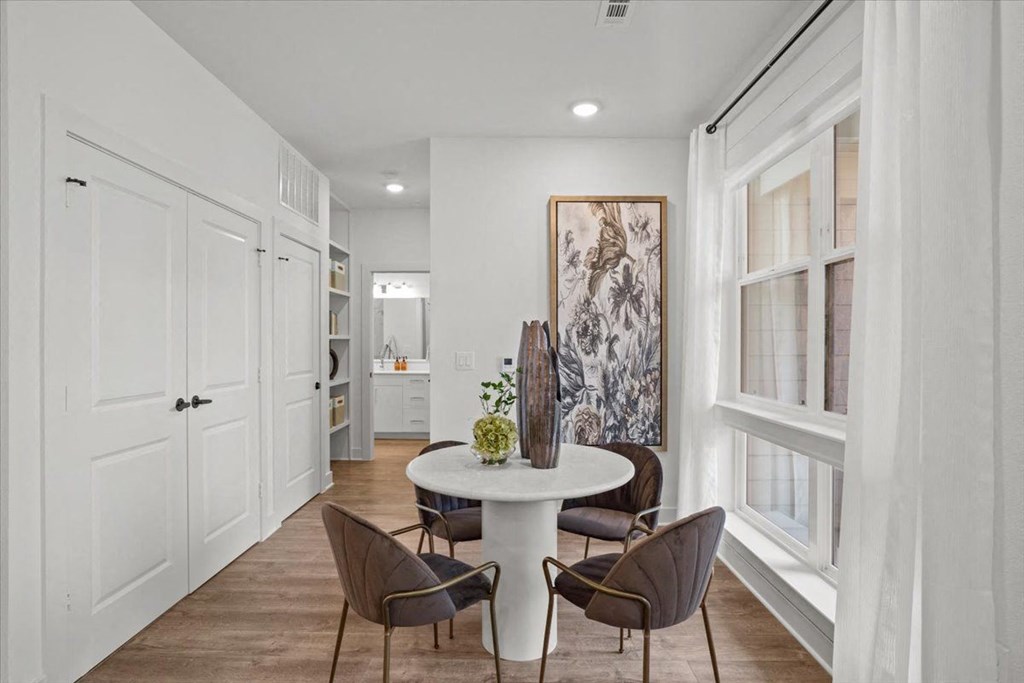 a dining room with a white table and chairs