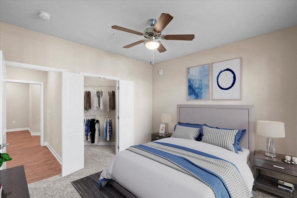 a bedroom with a large bed and a ceiling fan