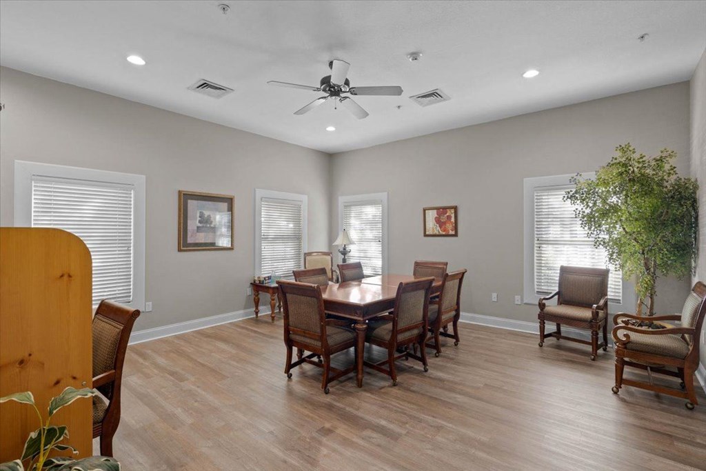 a dining room with a table and chairs and a ceiling fan at Somerset Oaks Apartment Homes, Olathe 66062