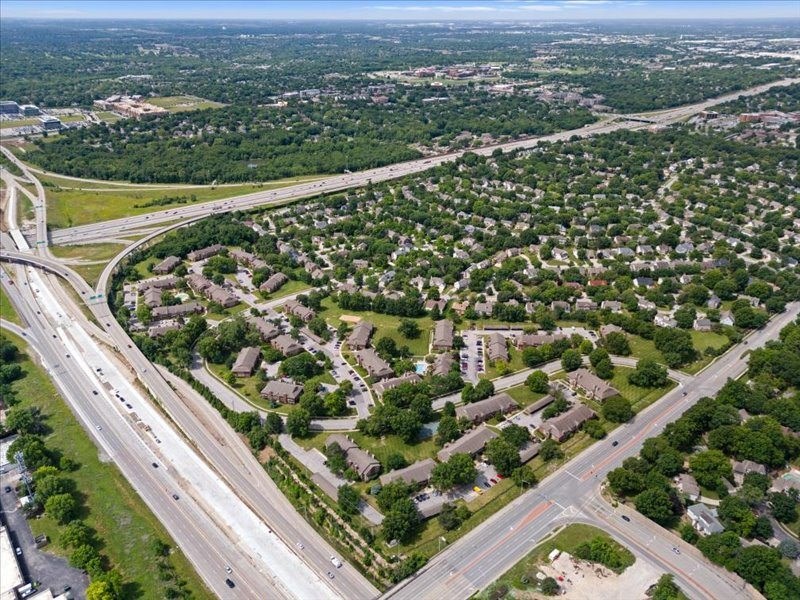 an aerial view of a city with highways and houses at Highland Park Apartment Homes, Kansas, 66214