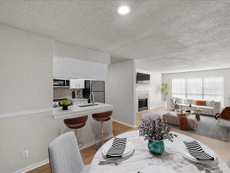 a kitchen and living room with a table and chairs