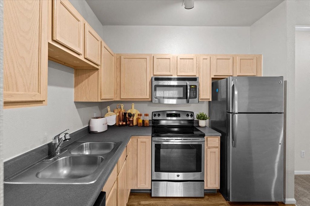 a kitchen with stainless steel appliances and wooden cabinets