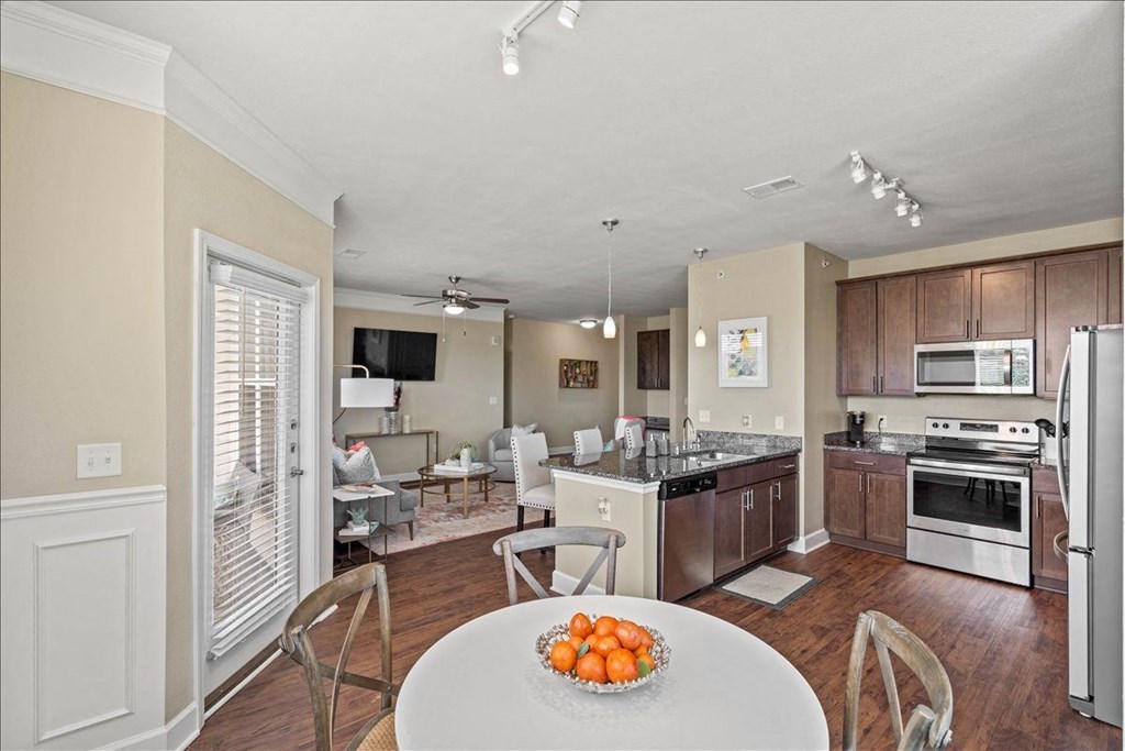 a kitchen and living room with a table and chairs at The Residences at Bluhawk Apartments, Kansas, 66085