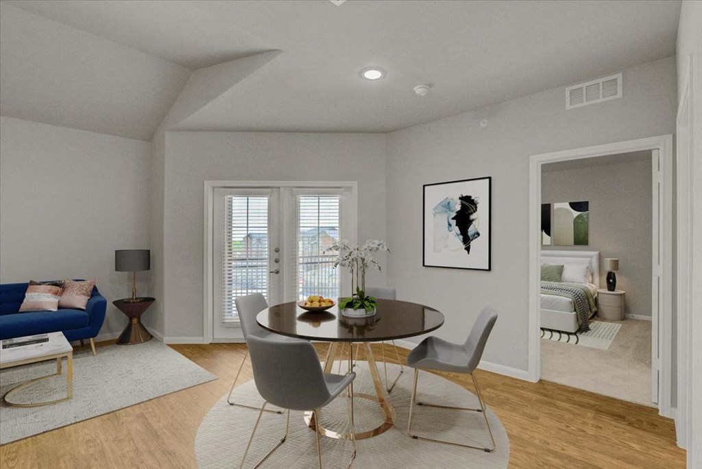 a living room and dining room with a table and chairs