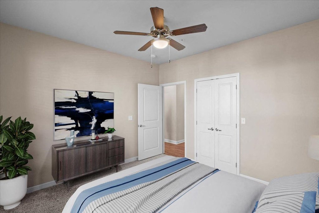 a bedroom with a bed and a ceiling fan