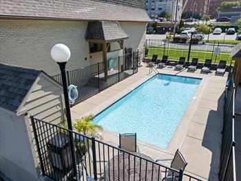A black iron fence surrounds a small pool. at Malvern Hill Apartment Homes, 66103, Kansas