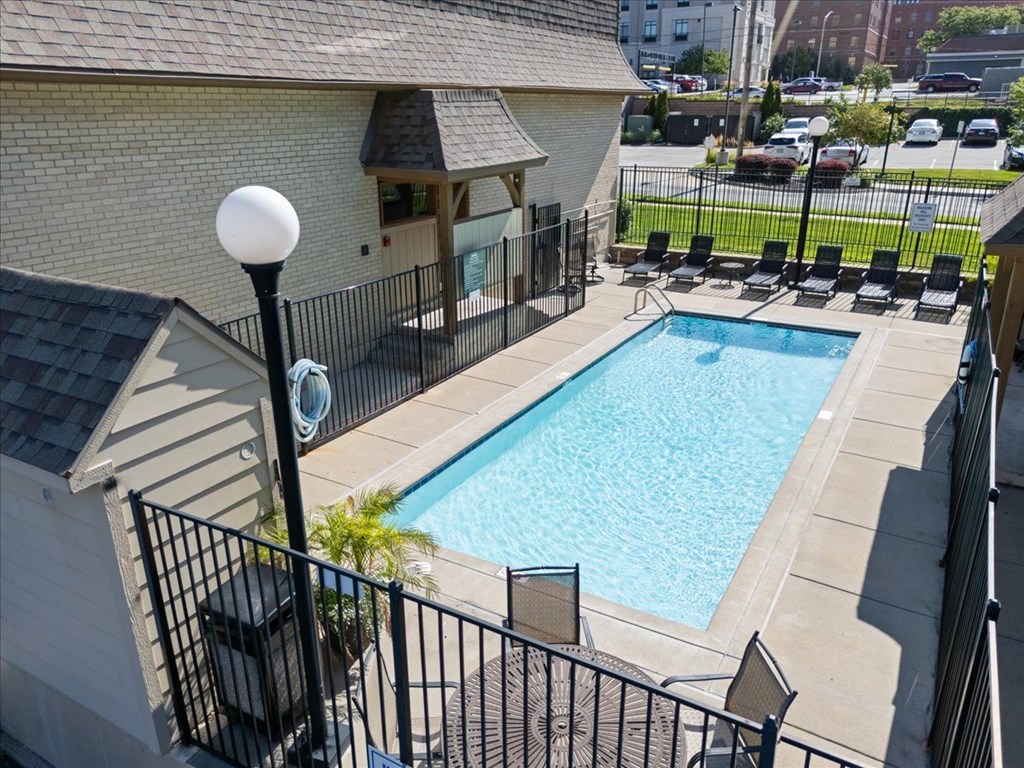 A black iron fence surrounds a small pool. at Malvern Hill Apartment Homes, Kansas, 66214