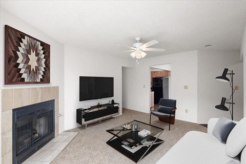 a living room with a fireplace and a tv at Deerfield Apartments, Olathe, KS